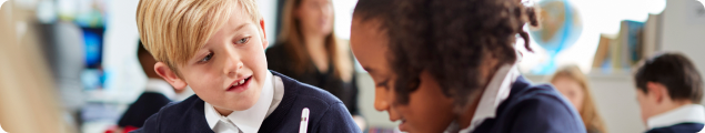 Two pupils talking in a classroom