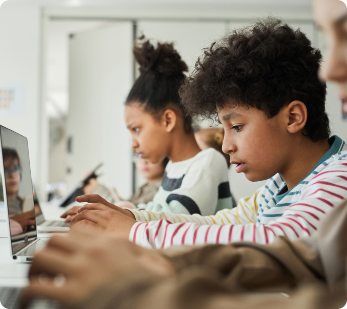 Children using laptops in a classroom