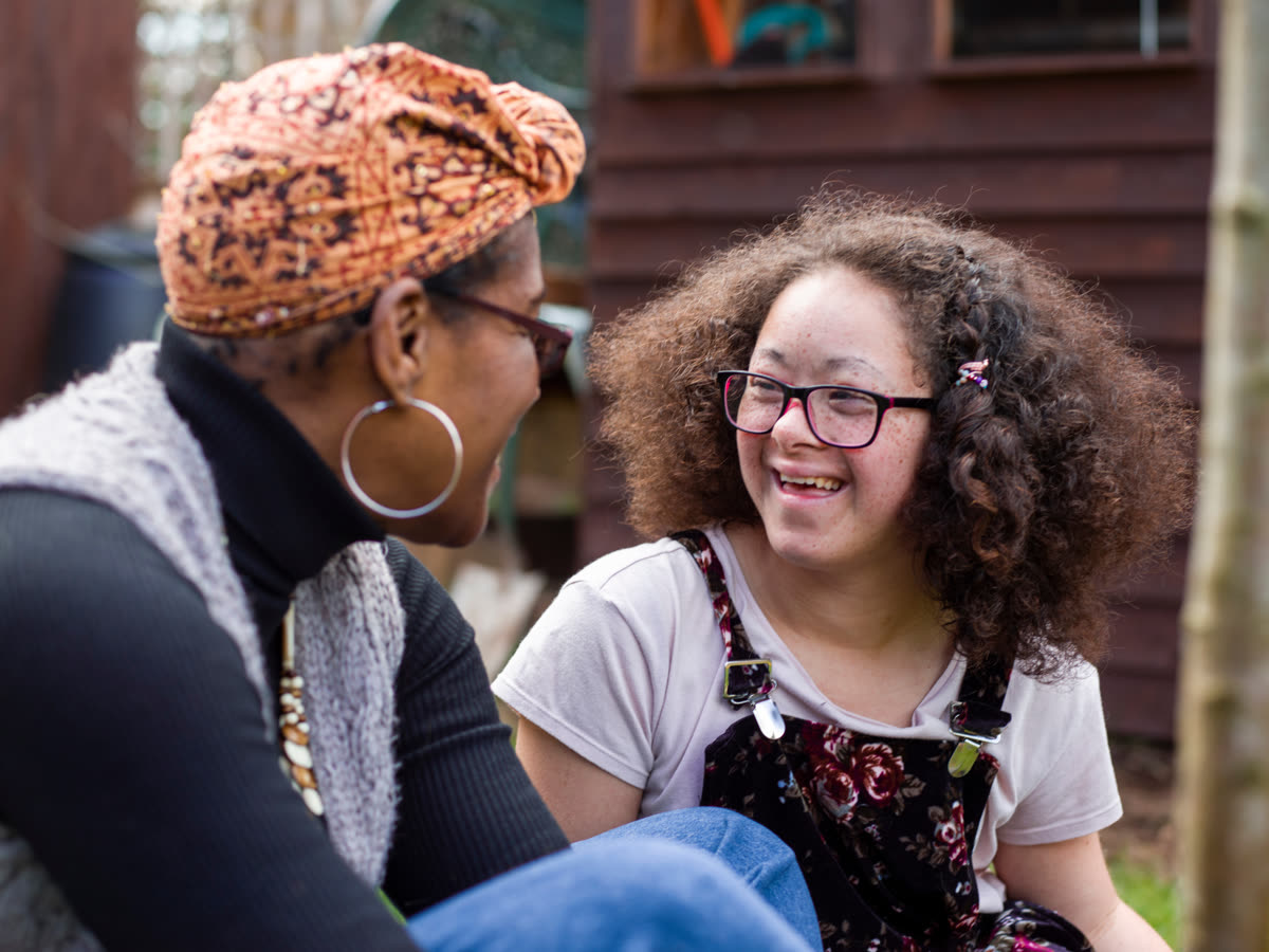 A child talking with a family member outdoors