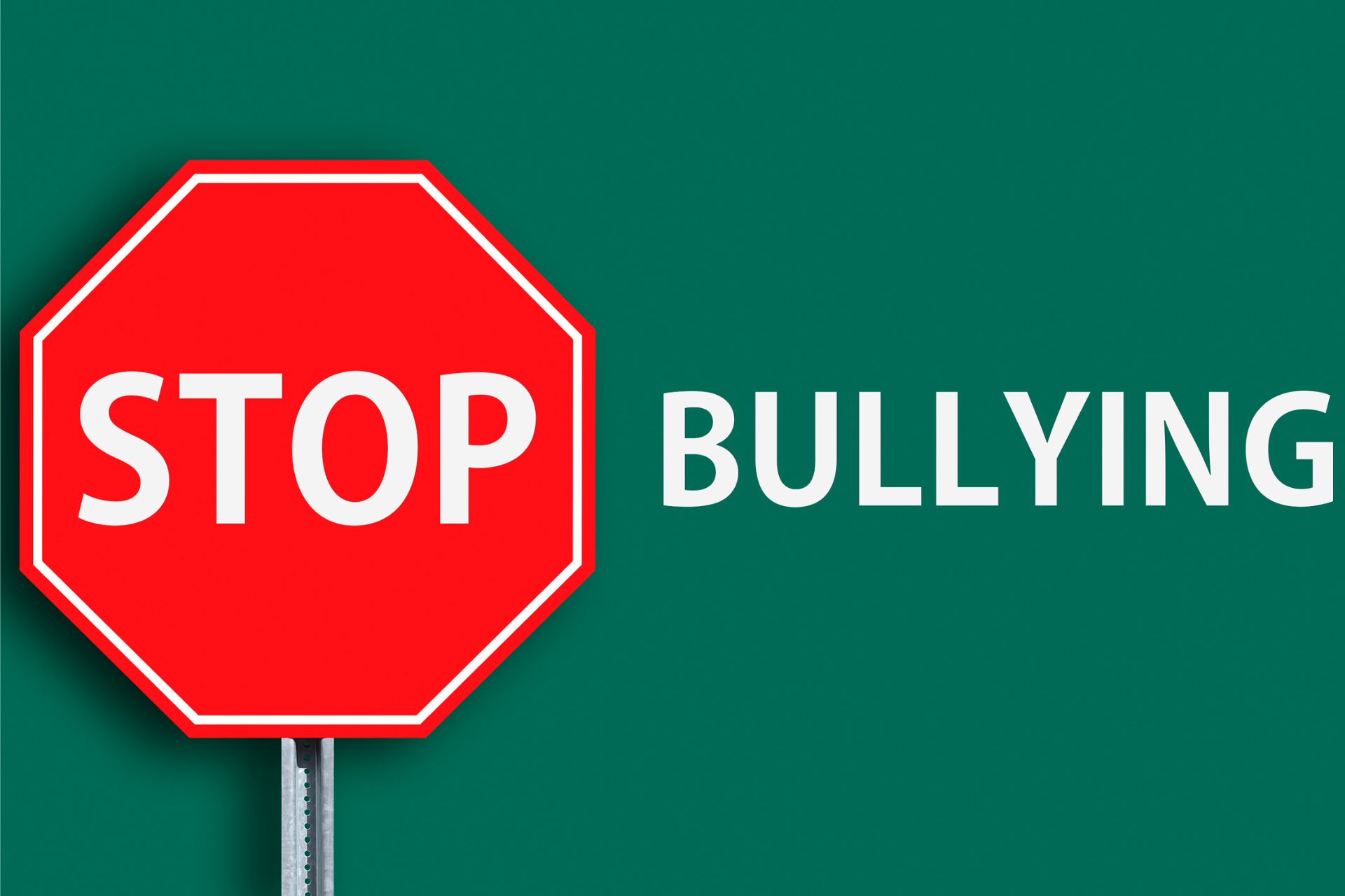 The words 'Stop Bullying' on a green background. The word "Stop" is displayed on a road sign.